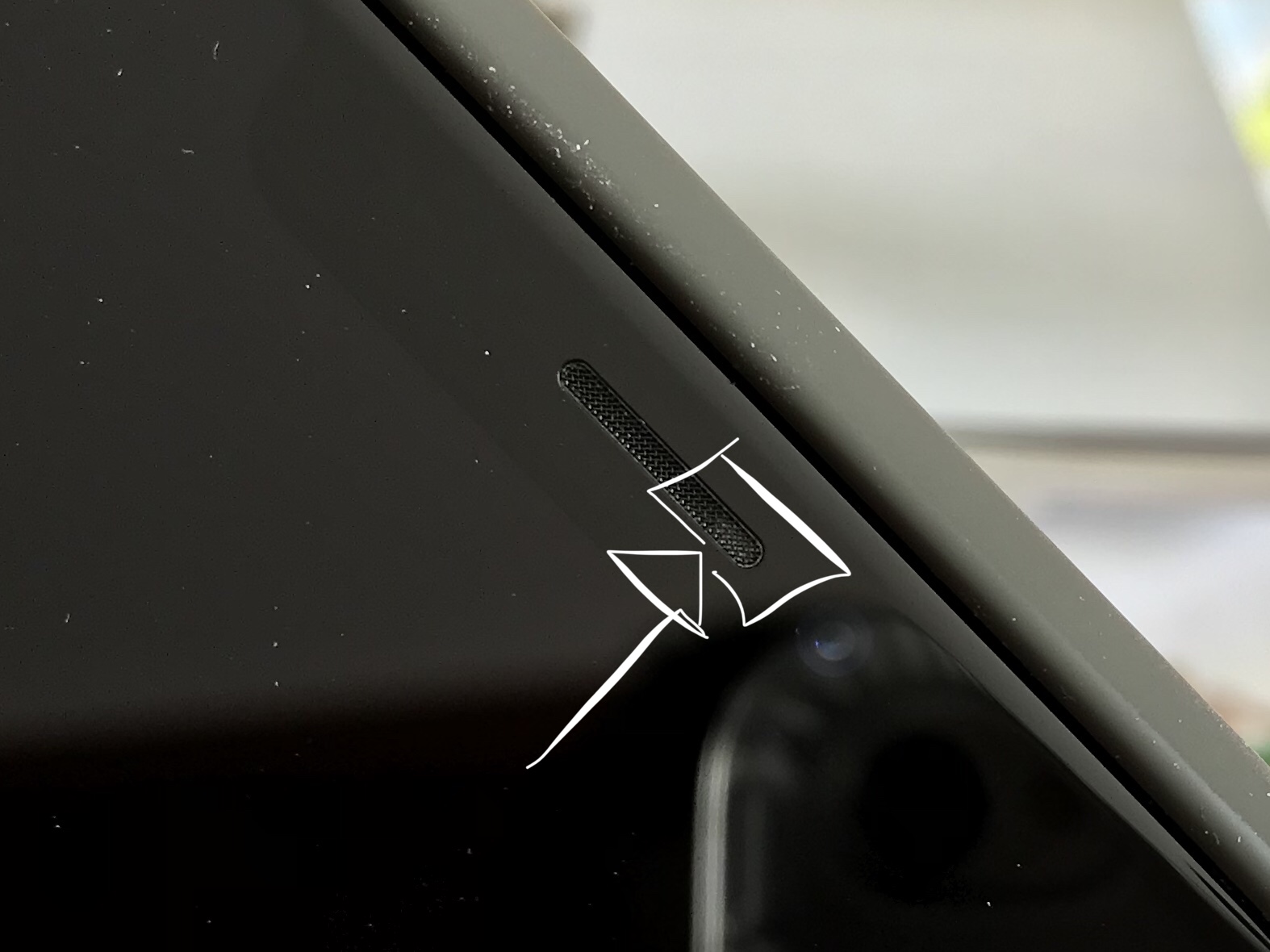 Grey “pill-shaped” area in earpiece speaker grill on iPhone X