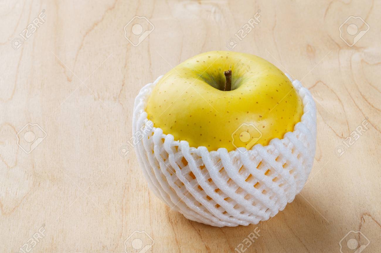 26505711-close-up-toki-japanese-apple-with-fruit-protection-foam-on-wooden-table.jpg