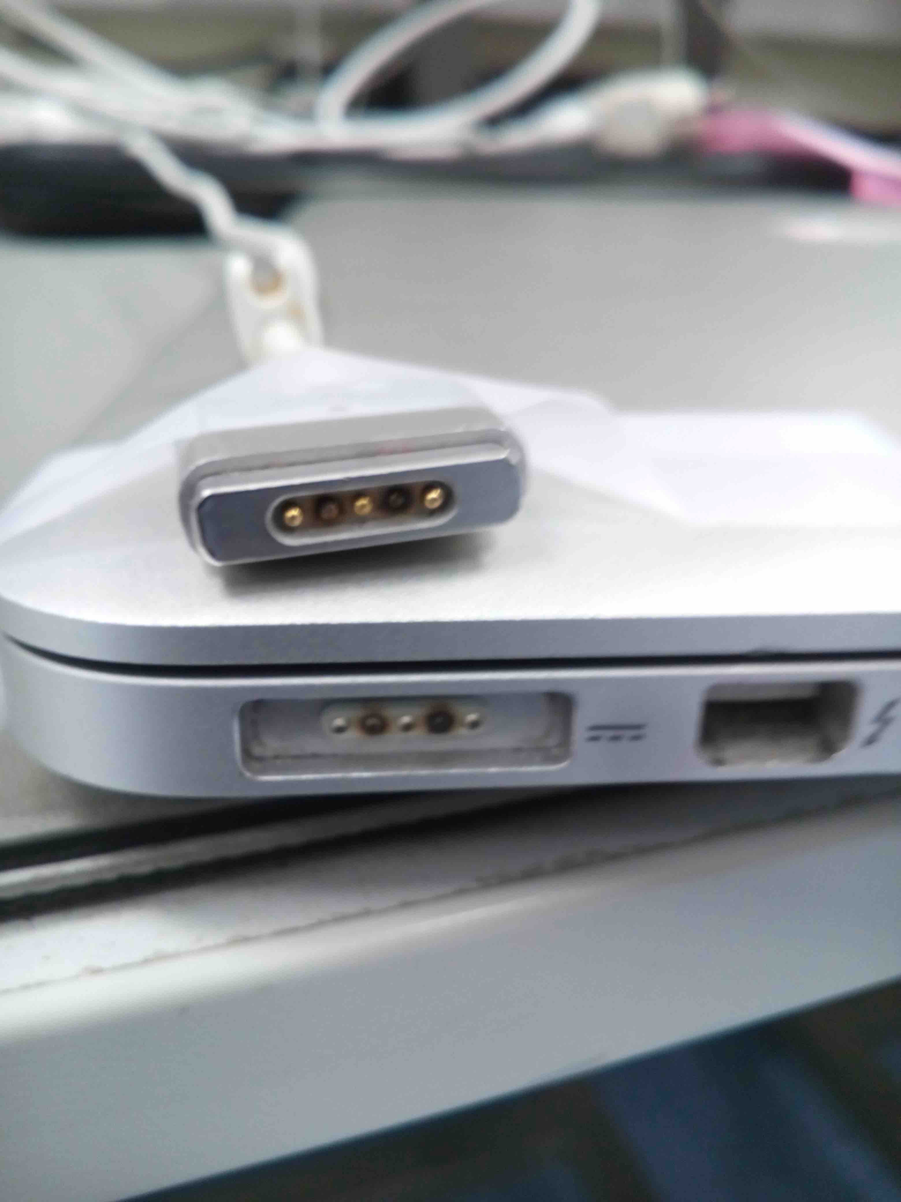 One of the pins in my magsafe 2 charger looks burnt. Is this okay? : r/mac