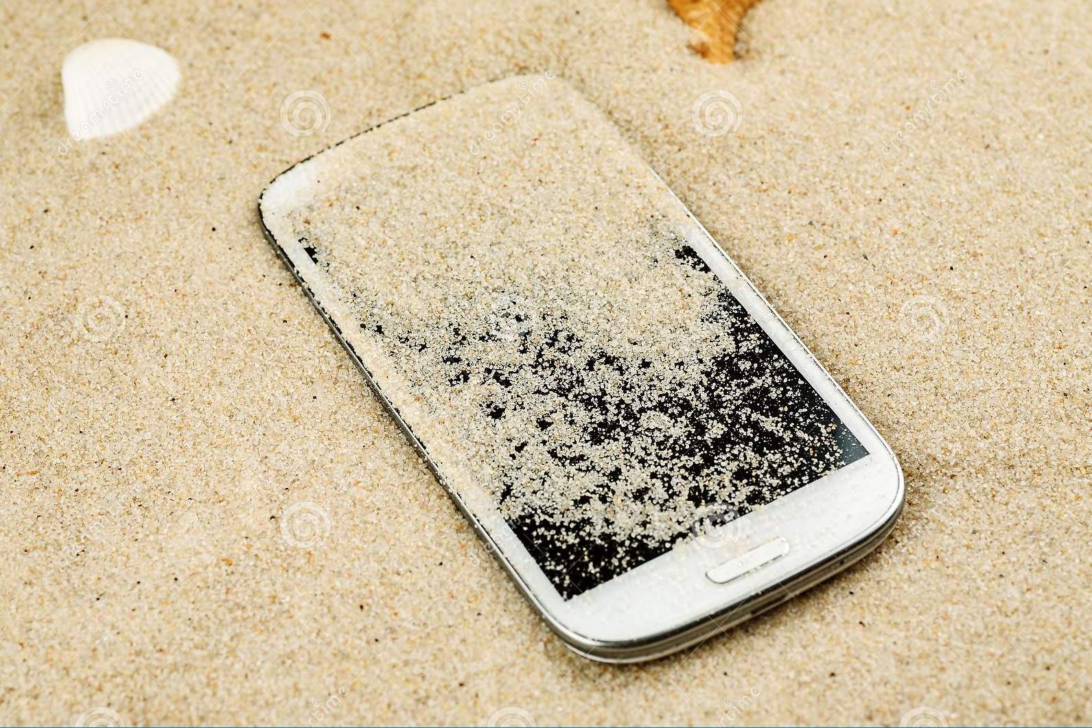 white-smartphone-lost-sand-beach-146500021.jpg