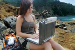 Pelican - 1080  Hardback Case - Girl sitting on rock in wilderness using laptop inside case[1].jpeg