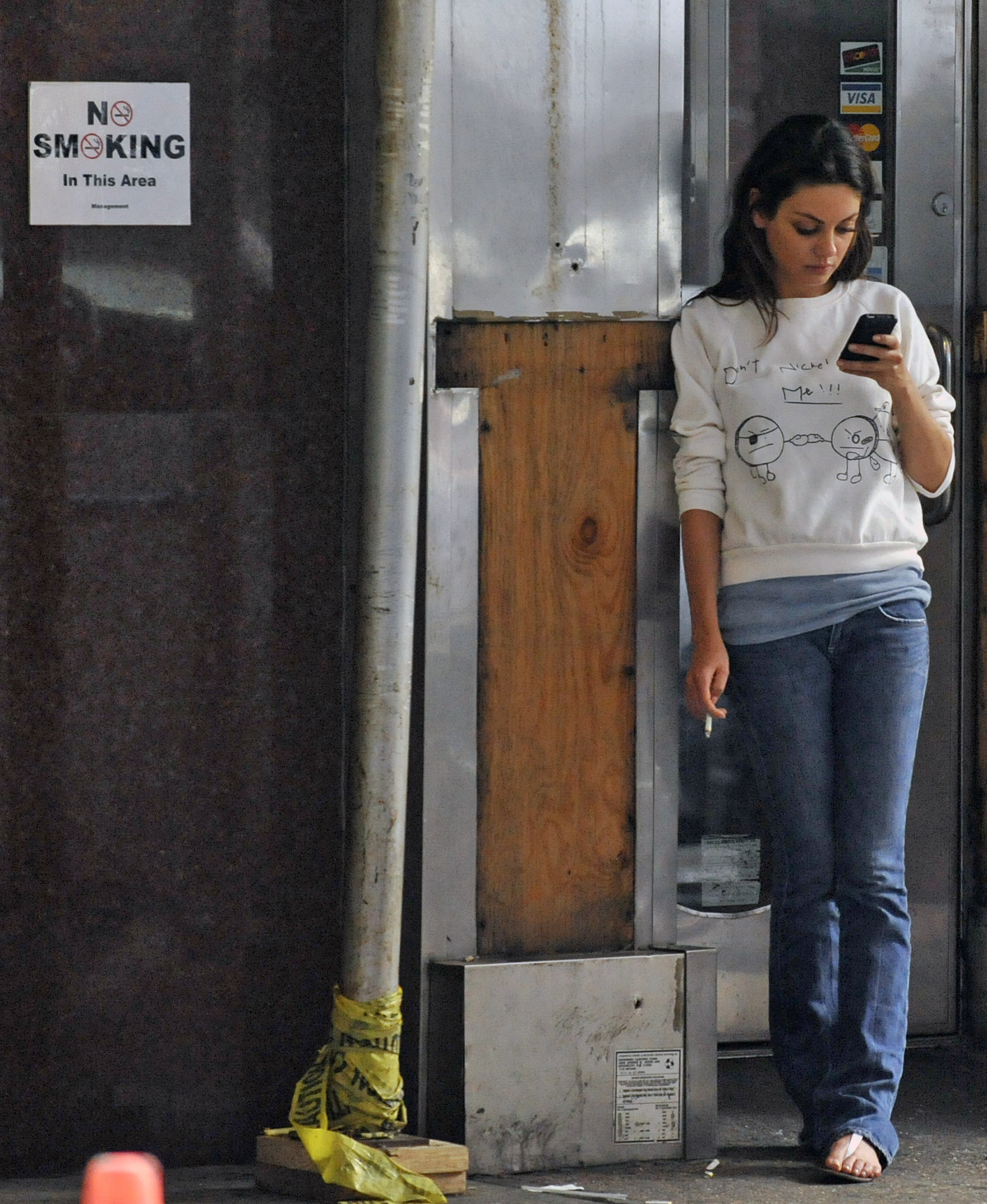 56408-mila-kunis-on-a-smoke-break-on-friends-with-.jpg