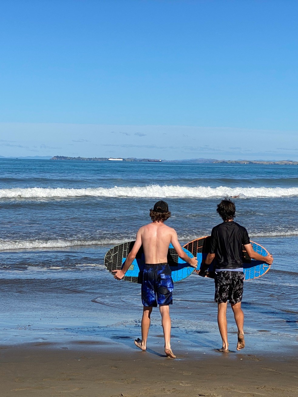 Boys skimboarding at Long Bay.jpg