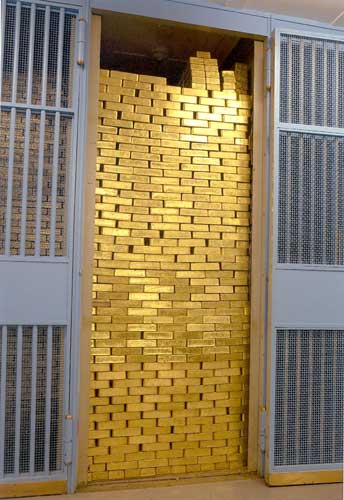 Gold_Bars_Stacked_in_a_Vault.jpg