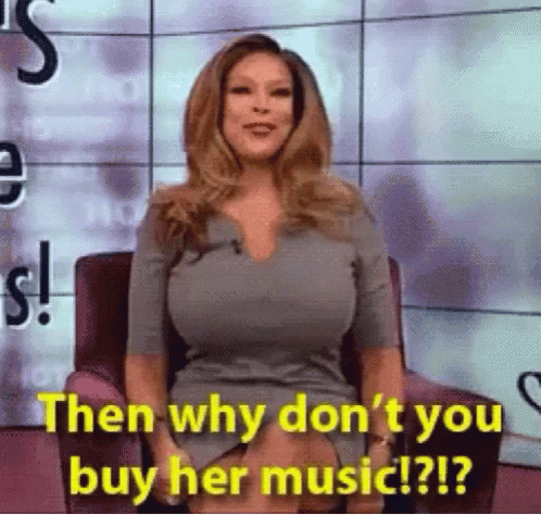 a woman is sitting in a chair and talking about music