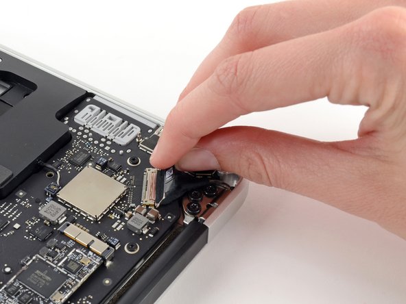 Pull the plastic tab on the display data cable connector to unlock it.