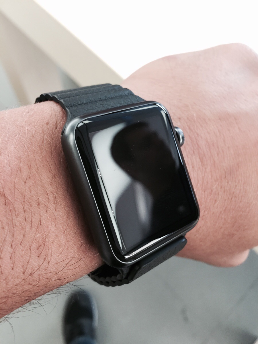 space gray apple watch with leather band